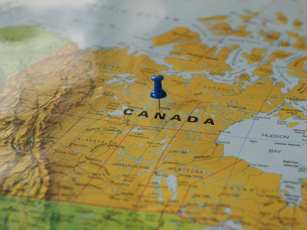 A pin is placed on a map of canada